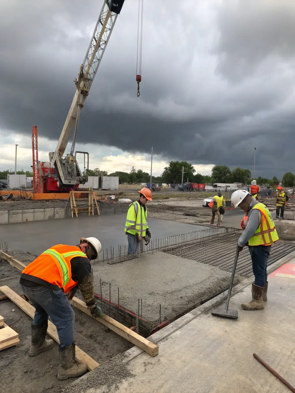 A wide shot of Bilir Talent One construction workers laying the foundation for a new building, emphasizing precision and adherence to safety standards in civil works.